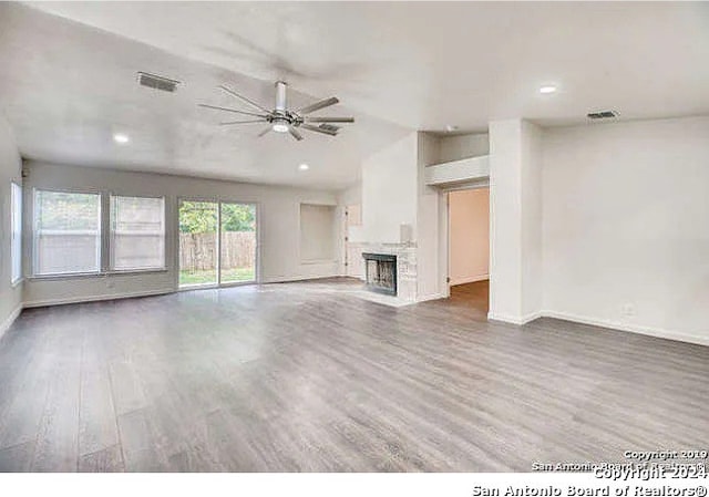 unfurnished living room featuring ceiling fan, lofted ceiling, and dark hardwood / wood-style floors