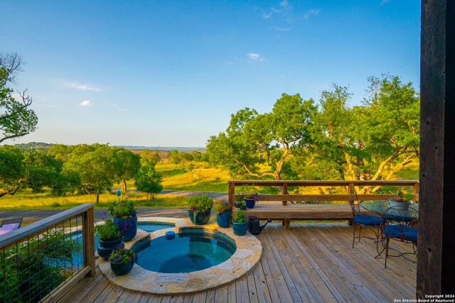 deck featuring an in ground hot tub