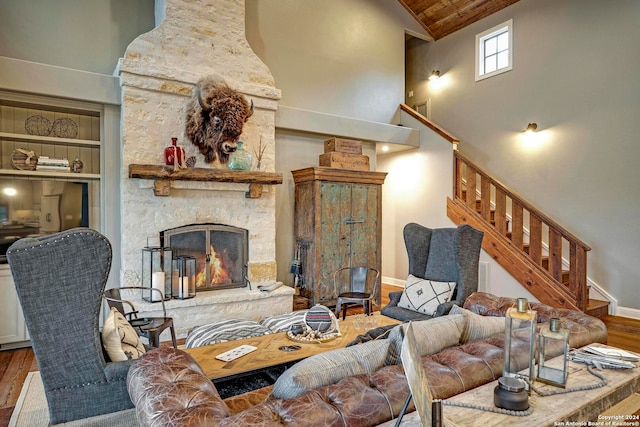 living room with a fireplace, high vaulted ceiling, and hardwood / wood-style flooring