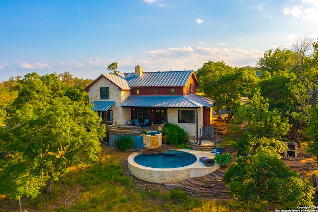 rear view of property featuring a patio area