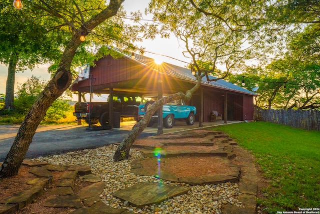 back house at dusk with a lawn