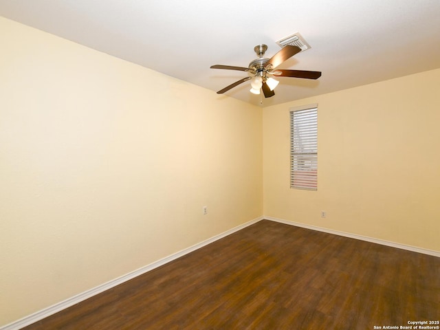 spare room with dark hardwood / wood-style flooring