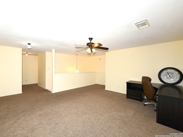 unfurnished office with dark colored carpet and ceiling fan