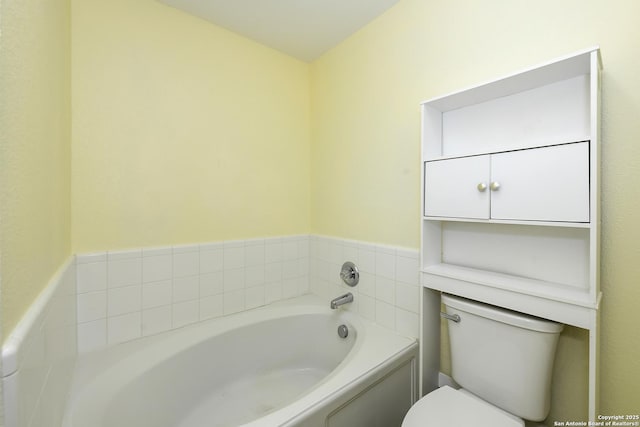 bathroom featuring a washtub and toilet