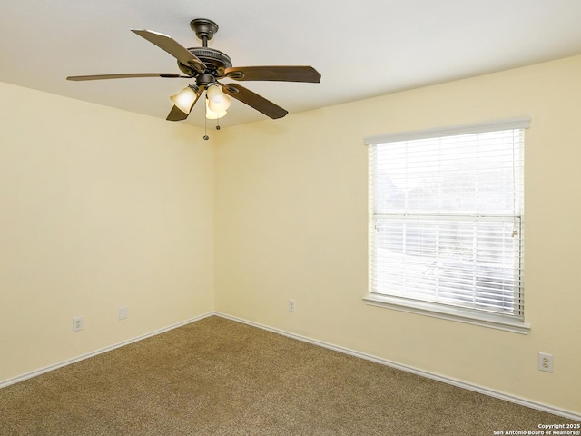 spare room featuring ceiling fan and carpet floors