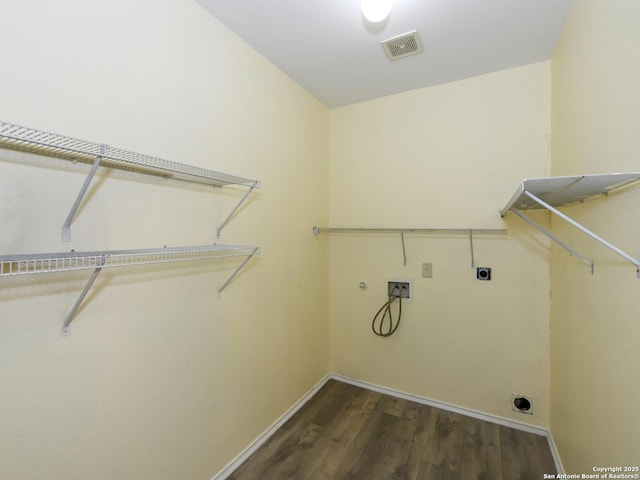 clothes washing area featuring electric dryer hookup, dark hardwood / wood-style flooring, and hookup for a washing machine