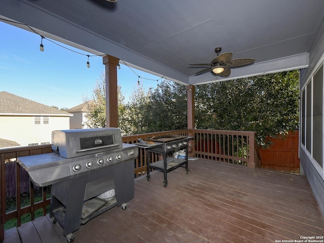 wooden deck with grilling area and ceiling fan