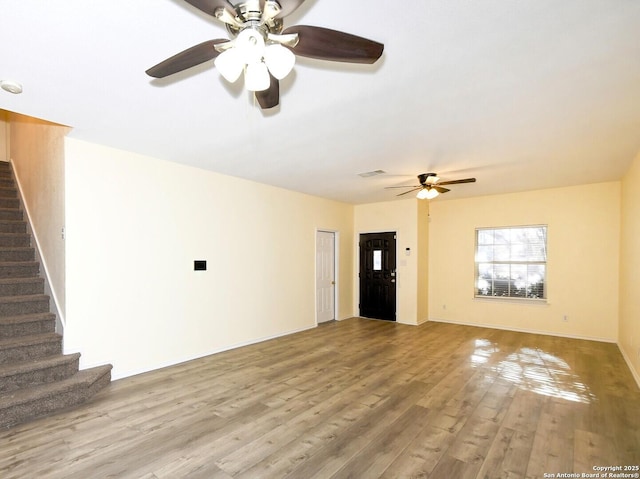 unfurnished living room featuring ceiling fan and light hardwood / wood-style floors