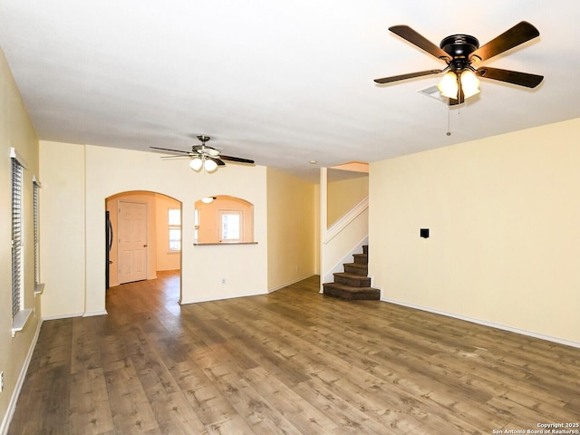 unfurnished living room with wood-type flooring and ceiling fan