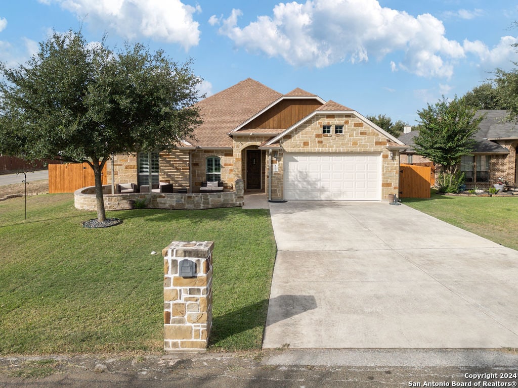 view of front of house with a garage and a front lawn