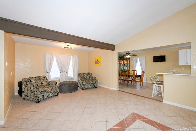 living area featuring lofted ceiling with beams, light tile patterned floors, and ceiling fan