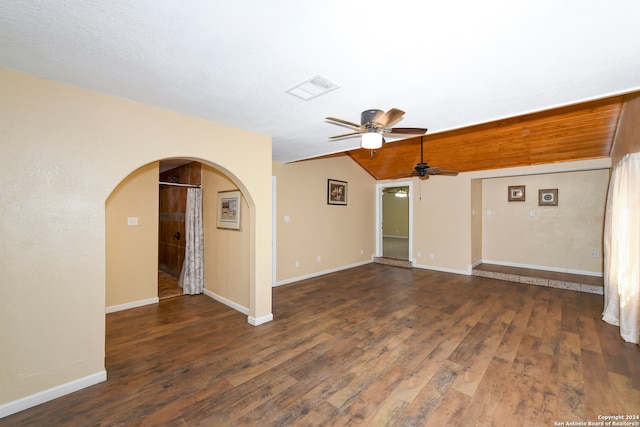 unfurnished living room featuring ceiling fan, vaulted ceiling, and dark hardwood / wood-style floors