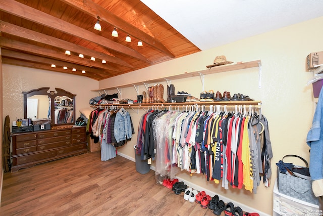 spacious closet with hardwood / wood-style flooring and beamed ceiling