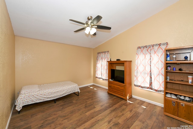 bedroom featuring dark hardwood / wood-style flooring, lofted ceiling, and ceiling fan