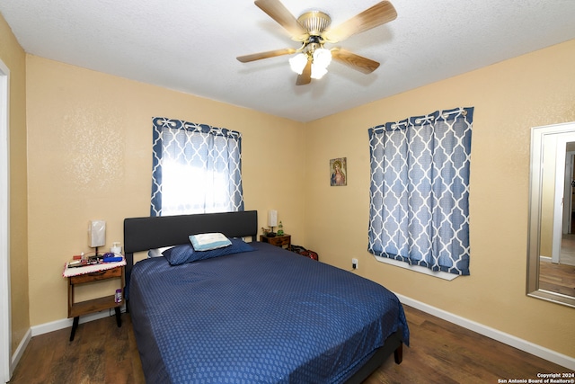 bedroom with ceiling fan and dark hardwood / wood-style floors