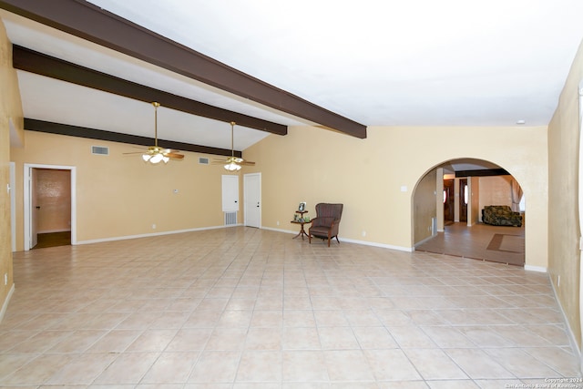 unfurnished room with light tile patterned flooring and lofted ceiling with beams