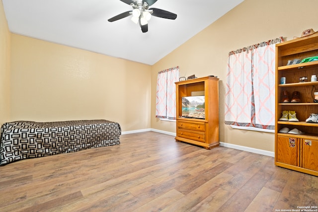 bedroom with hardwood / wood-style flooring, ceiling fan, and lofted ceiling