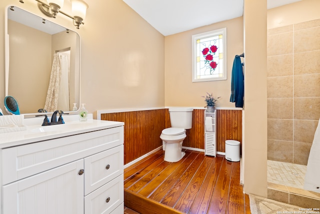 bathroom featuring walk in shower, hardwood / wood-style floors, and vanity