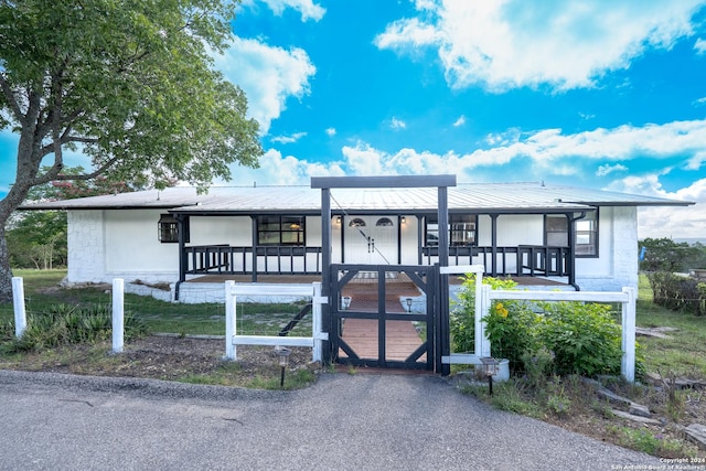 355 Mountain Creek Rd, Pipe Creek, TX 78063 - view of front of home with covered porch, metal roof, and a gate