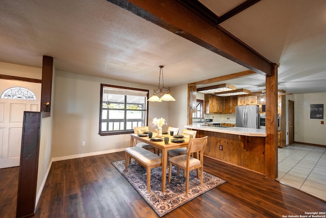 355 Mountain Creek Rd, Pipe Creek, TX 78063 - dining space with wood finished floors, baseboards, and a textured ceiling