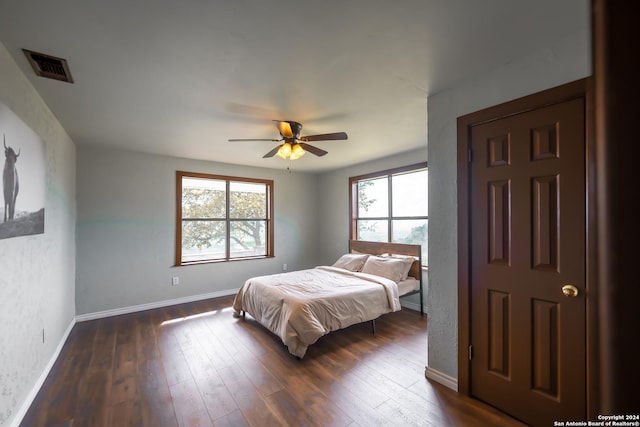 355 Mountain Creek Rd, Pipe Creek, TX 78063 - bedroom with baseboards, dark wood-style floors, and a ceiling fan