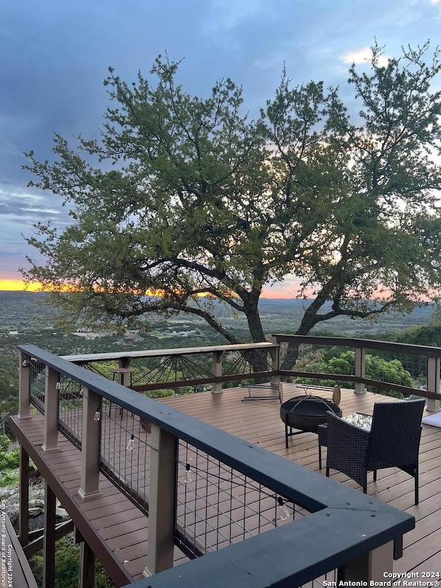 355 Mountain Creek Rd, Pipe Creek, TX 78063 - deck at dusk featuring an outdoor fire pit