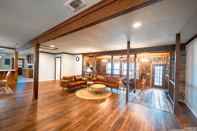 355 Mountain Creek Rd, Pipe Creek, TX 78063 - living room featuring ceiling fan, wooden walls, wood finished floors, baseboards, and ornamental molding