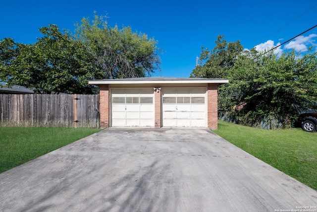 garage featuring a lawn