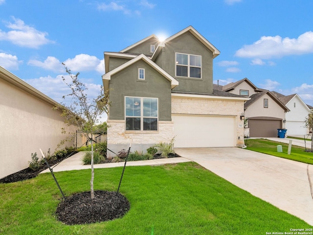 traditional home with stone siding, a front yard, concrete driveway, and stucco siding