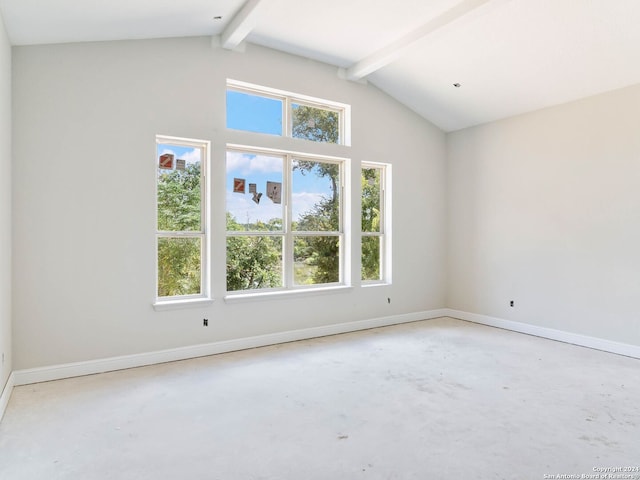 spare room featuring vaulted ceiling with beams