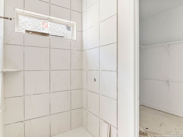 bathroom with a tile shower