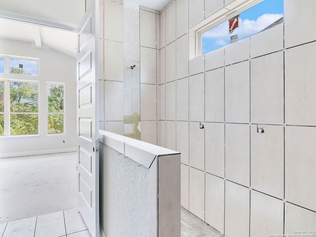 bathroom with lofted ceiling with beams and tile patterned flooring