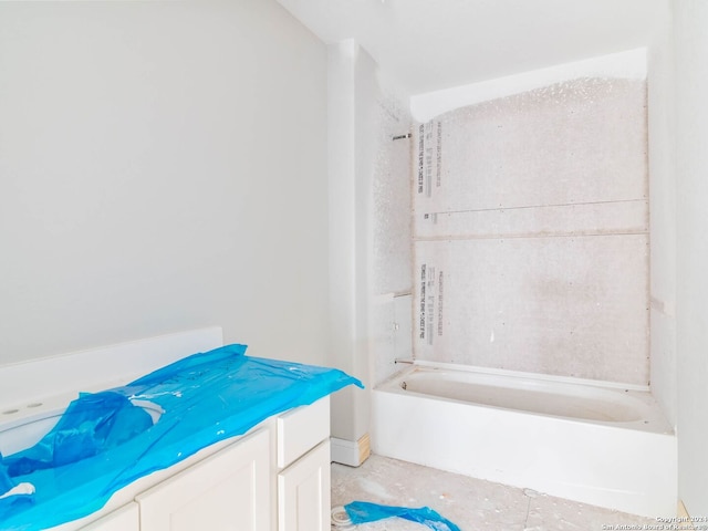 bathroom featuring tiled shower / bath combo and vanity