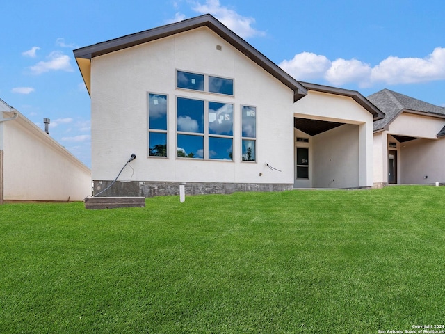 rear view of property with a yard