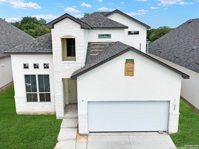 view of front of home featuring a front yard and a garage