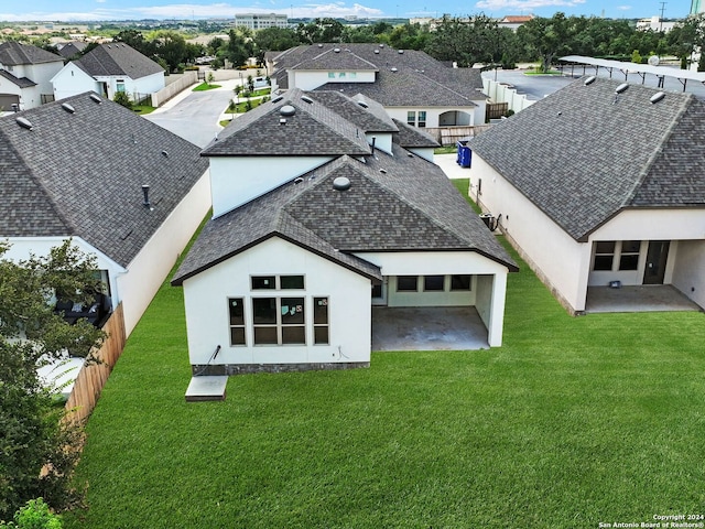 back of house featuring a yard and a patio area