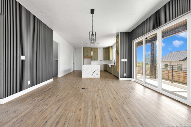 unfurnished living room featuring a textured ceiling, hardwood / wood-style floors, and sink