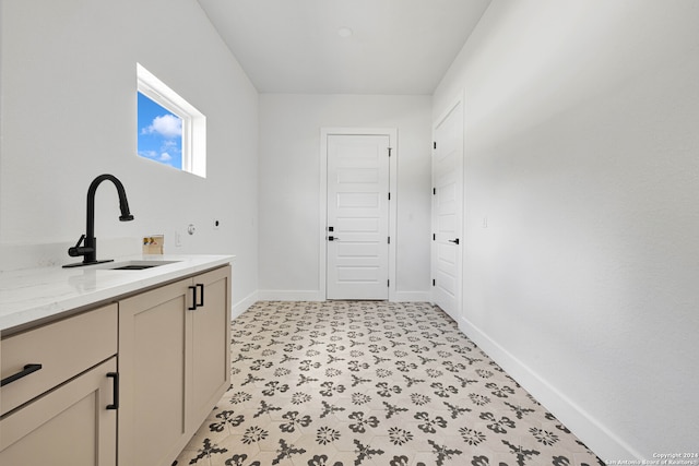 laundry area featuring cabinets, washer hookup, and sink