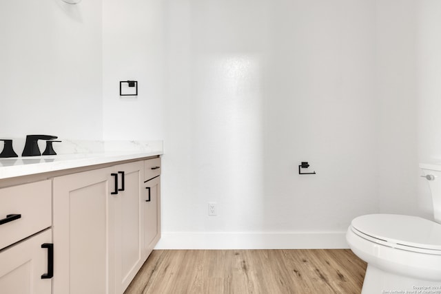 bathroom with vanity, hardwood / wood-style floors, and toilet