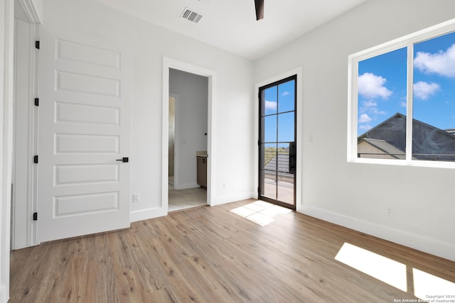 unfurnished bedroom with connected bathroom and light hardwood / wood-style floors