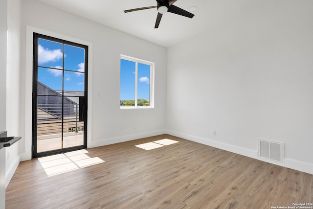 spare room with light wood-type flooring and ceiling fan