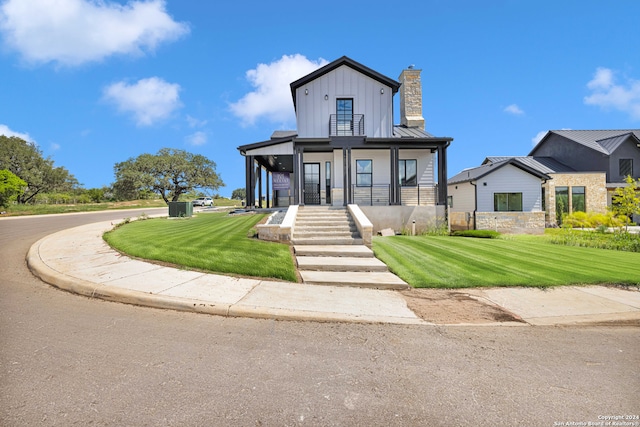 modern inspired farmhouse with a front lawn and a porch