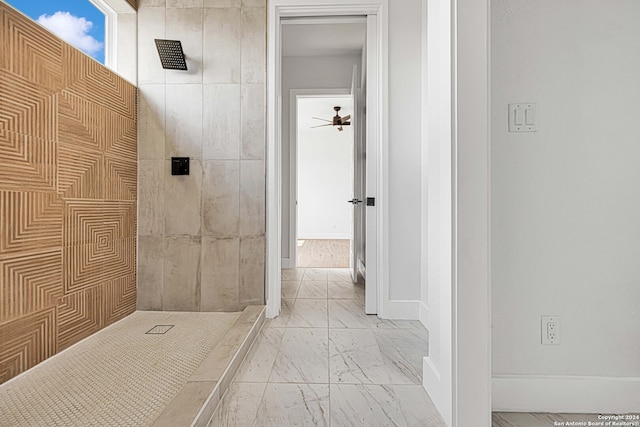 bathroom featuring ceiling fan and a tile shower