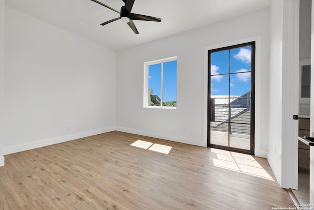 empty room featuring light hardwood / wood-style flooring, ceiling fan, and a wealth of natural light