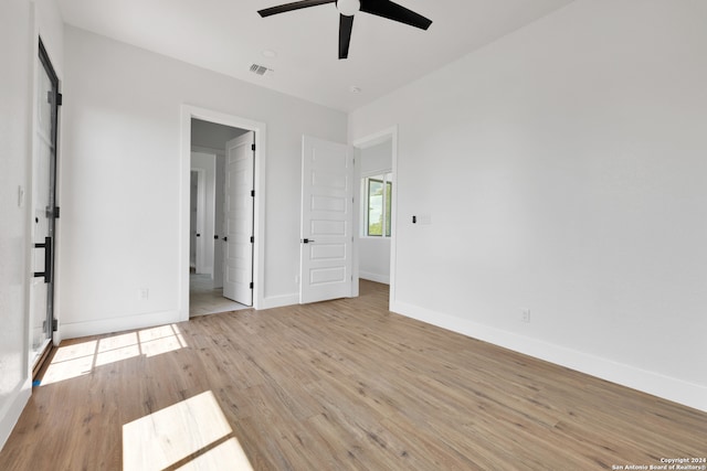 unfurnished bedroom with ceiling fan and light hardwood / wood-style floors