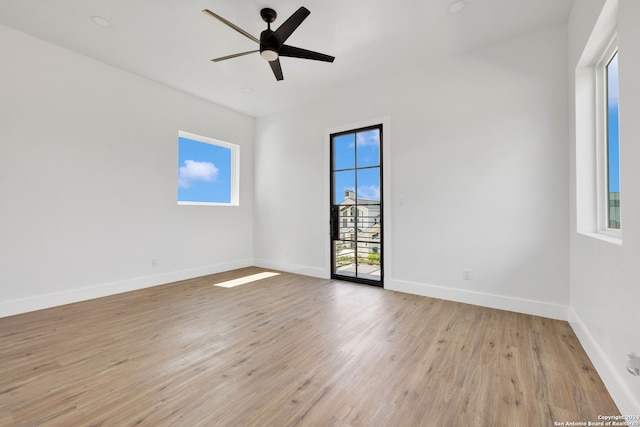 unfurnished room with light wood-type flooring and ceiling fan