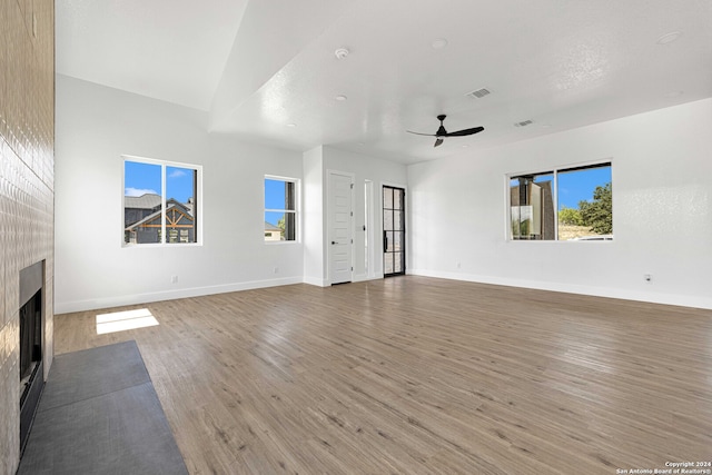 unfurnished living room with ceiling fan, hardwood / wood-style flooring, a textured ceiling, and a high end fireplace