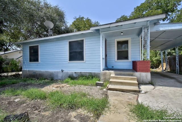 view of front of home with a carport