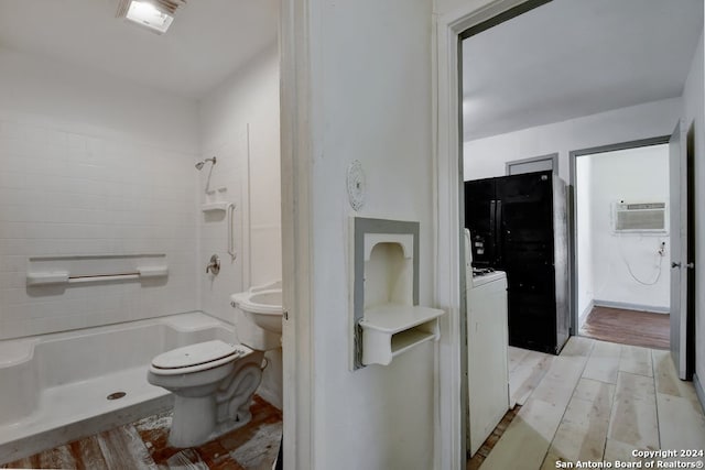 bathroom featuring tiled shower, toilet, a wall unit AC, and hardwood / wood-style flooring