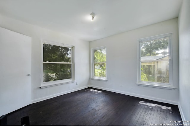 spare room with dark hardwood / wood-style floors